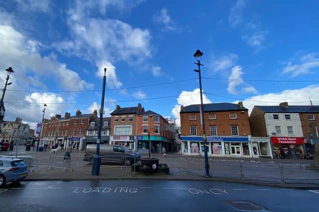Vehicles parked on Market Place, Melton, this week despite temporary barriers being installed to stop them