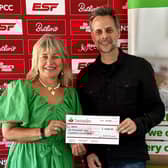 Martyn Young, director at ESF Events, presents a cheque for more than £6,000 to Barbara Elsey, the NSPCC’s Community Fundraising Manager for the East Midlands, from this year's fundraising effort for the charity