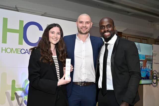 Peter Bryan (centre), registered manager at Bluebird Care Rushcliffe & Melton, picks up their national award on presentation night