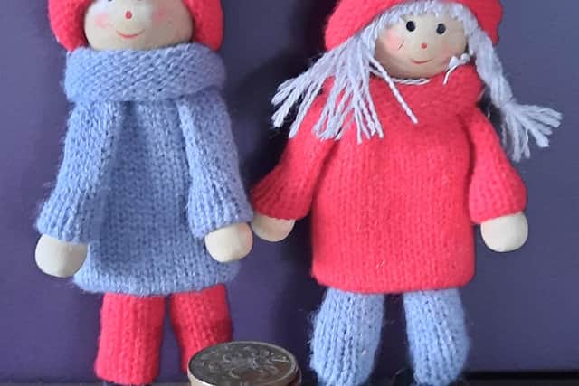 Knitted characters illustrating the male and female financial divide