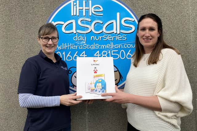 Debra Meakin (Cheeky Cherubs Childcare) presents a LifeVac anti-choking device to Little Rascals founder, Liz Raine (right)