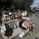 Fly-tipped rubbish and waste is seen beside a road in Colnbrook, near Heathrow, west of London on May 11 2020.