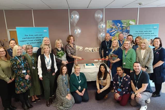 Colleagues gather to celebrate the launch of the Healthy Together Helpline, with director of families, young people, children, learning disability and autism services at Leicestershire Partnership NHS Trust, Helen Thompson (centre), cutting a ribbon to mark the occasion