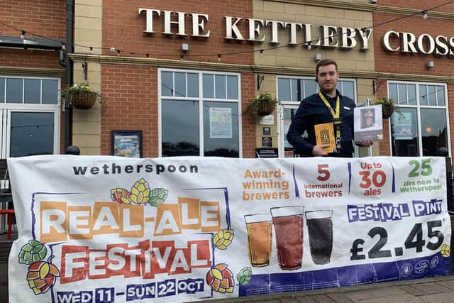 Shift leader Joe Carvell celebrates The Kettleby Cross being included in the latest edition of the Good Beer Guide