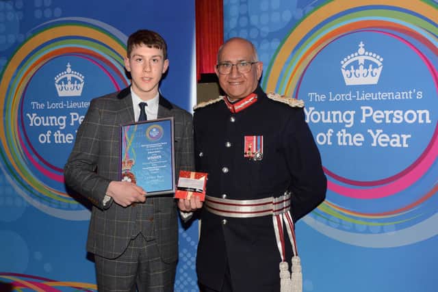 Lord Lieutenant of Leicestershire, Mike Kapur, hands over the Young Person of the Year Award 2023 to Joshua Bailey