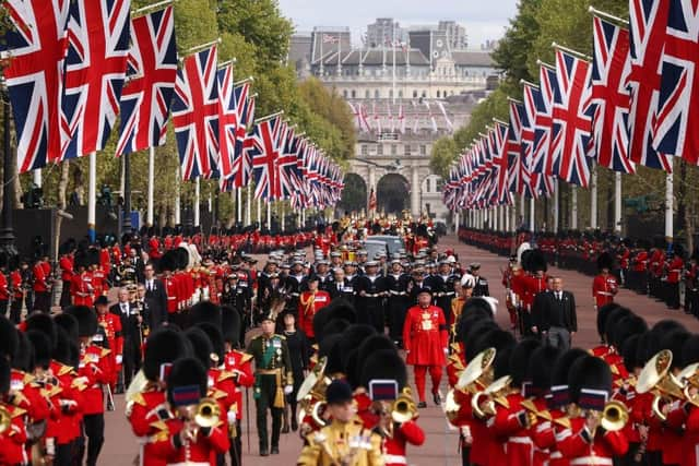 LONDON, ENGLAND - SEPTEMBER 19: The Queen's funeral cortege borne on the State Gun Carriage of the Royal Navy travels along The Mall with the Gentlemen at Arms on September 19, 2022 in London, England. Elizabeth Alexandra Mary Windsor was born in Bruton Street, Mayfair, London on 21 April 1926. She married Prince Philip in 1947 and ascended the throne of the United Kingdom and Commonwealth on 6 February 1952 after the death of her Father, King George VI. Queen Elizabeth II died at Balmoral Castle in Scotland on September 8, 2022, and is succeeded by her eldest son, King Charles III.  (Photo by Dan Kitwood/Getty Images)