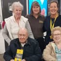 Residents of Melton Mowbray's Wilton Manor care home present funds to staff at The Hanger charity superstore