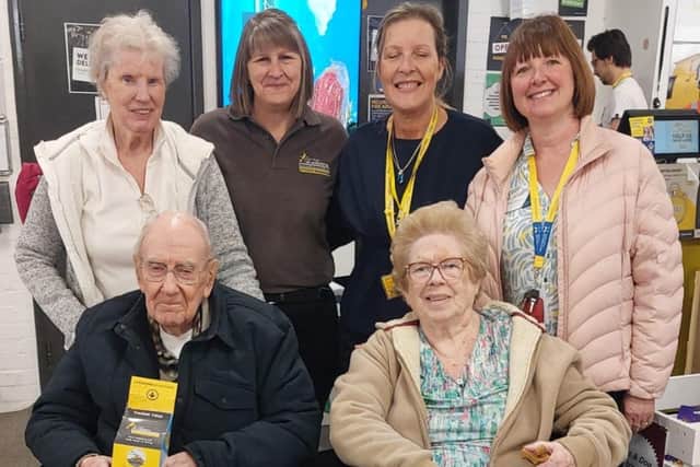 Residents of Melton Mowbray's Wilton Manor care home present funds to staff at The Hanger charity superstore