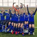 Members of the Whitwick St John Baptist School girls' football team celebrating their new kits
