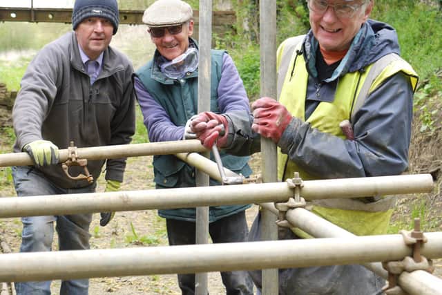 MOWS members Jerry Filor, Bob Fisher and Mick Clowes erecting scaffolding to gain access to the tops of the wall at Thrussington Lock