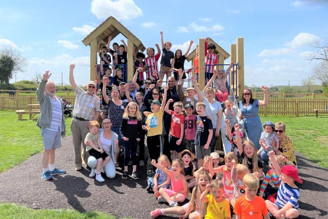 Villagers celebrate the opening of their new playground at Great Dalby