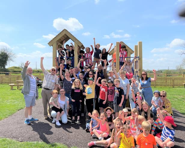 Villagers celebrate the opening of their new playground at Great Dalby