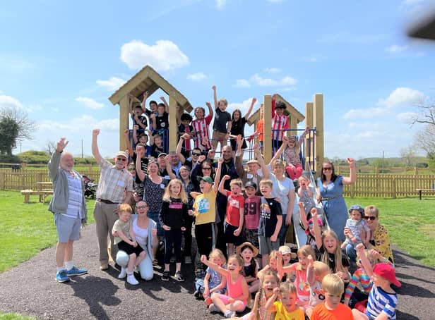 Villagers celebrate the opening of their new playground at Great Dalby