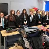 Students at Melton's Long Field Spencer Academy pictured with donating items last year for refugees being housed at a local hotel