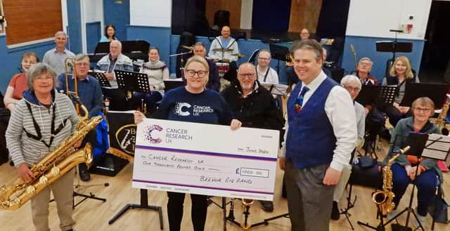 Belvoir Big Band present a cheque to Becky Elphick, of Cancer Research UK