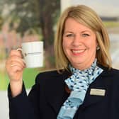 BG - A David Wilson Homes Sales Adviser holding a mug of tea