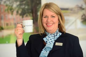 BG - A David Wilson Homes Sales Adviser holding a mug of tea