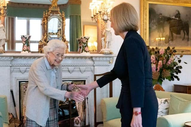 ABERDEEN, SCOTLAND - SEPTEMBER 06: Queen Elizabeth greets newly elected leader of the Conservative party Liz Truss as she arrives at Balmoral Castle for an audience where she will be invited to become Prime Minister and form a new government on September 6, 2022 in Aberdeen, Scotland. The Queen broke with the tradition of meeting the new prime minister and Buckingham Palace, after needing to remain at Balmoral Castle due to mobility issues. (Photo by Jane Barlow - WPA Pool/Getty Images)