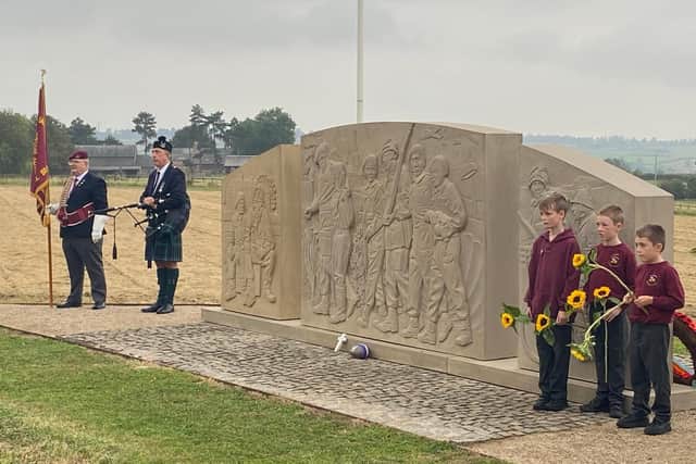 Pupils from Somerby Primary School at the war memorial to the 10th Battalion at Burrough-on-the-hill