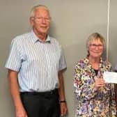 President Gordon Wells (right) and fellow Rotary member Derek Simmonds present cheque for £10,000 to Janet Gilchrist, secretary of the
local Macmillan group, from the proceeds of a concert by Grimethorpe Colliery Band