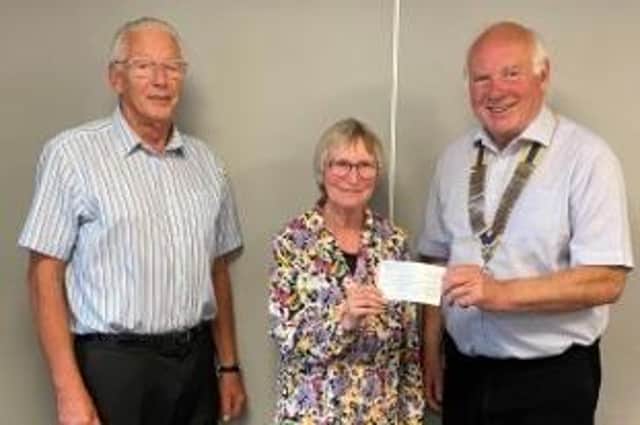 President Gordon Wells (right) and fellow Rotary member Derek Simmonds present cheque for £10,000 to Janet Gilchrist, secretary of the
local Macmillan group, from the proceeds of a concert by Grimethorpe Colliery Band