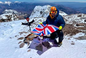 Chris Foster at the summit of Mount Aconcagua in Argentina