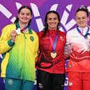 Silver medallist Australia's Iona Alexandra Anderson (L), gold medallist Canada's Kylie Masse (C) and bronze medallist England's Lauren Cox celebrate during the Women's 50m Backstroke Medal Ceremony at the swimming event at the Tollcross International Swimming Centre in Glasgow, on day five of the Commonwealth Games in Glasgow, Scotland, on July 28, 2026. (Photo by Oli SCARFF / AFP via Getty Images)