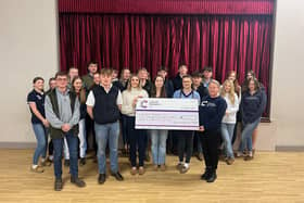 Members of Melton young farmers hand over a cheque to Cancer Research UK