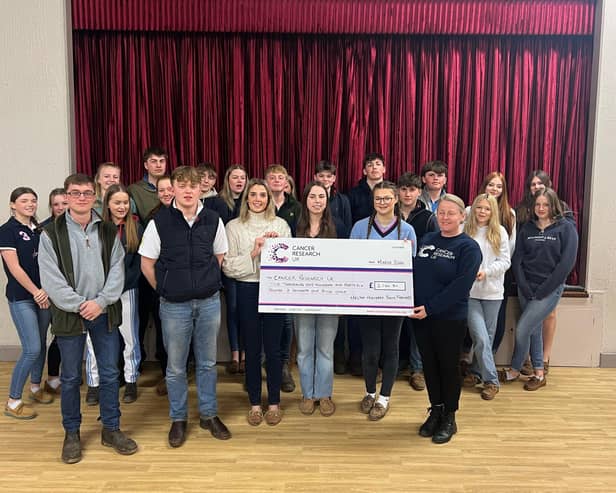 Members of Melton young farmers hand over a cheque to Cancer Research UK