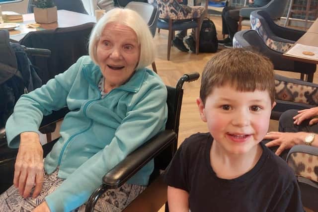 A resident at Wilton Manor care home in Melton enjoys meeting one of the children from Melton Mowbray Nursery