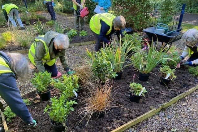 Melton In Bloom volunteers work on the planting in the Stephen’s Footprints baby memorial garden in Melton Country Park