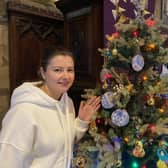 Melton Christmas tree festival opens to the public - Natalia Bahrova by the tree provided by Ukrainian guests of Melton