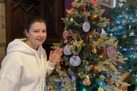 Melton Christmas tree festival opens to the public - Natalia Bahrova by the tree provided by Ukrainian guests of Melton