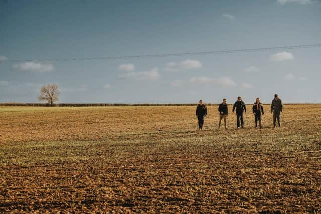 Agriculture students and staff in a field at Brooksby's college campus