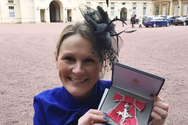 Claire Lomas with her MBE after being presented with it by Prince William in 2017