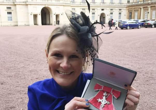 Claire Lomas with her MBE after being presented with it by Prince William in 2017