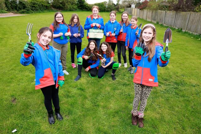 Wymeswold Girl Guides show off the gardening equipment gifted by housebuilders, Dandara