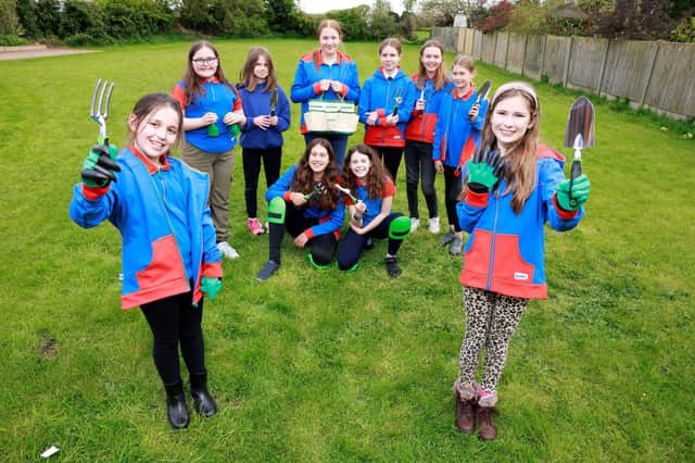 Wymeswold Girl Guides show off the gardening equipment gifted by housebuilders, Dandara