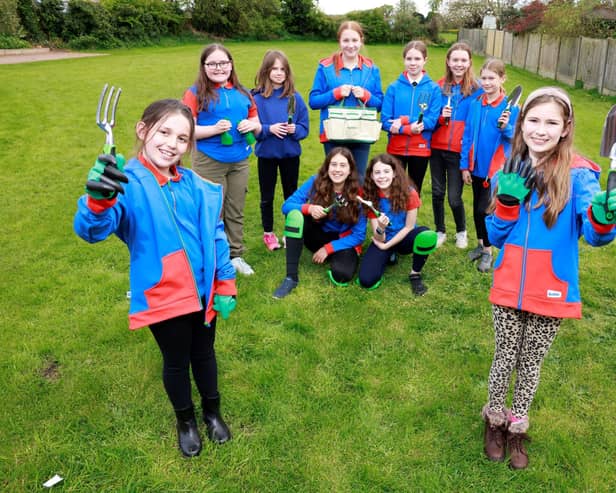 Wymeswold Girl Guides show off the gardening equipment gifted by housebuilders, Dandara
