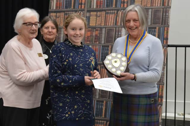 Overall local Young Rotary Musician winner, Harriet Devenyi, is presented with her shield by presidents Pam Posnett and Brenda Clayton