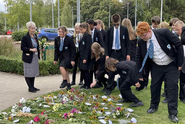 Long Field Spencer Academy students place homegrown flowers outside the council offices in tribute to The Queen