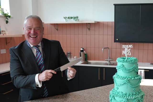 Simon Taylor, CEO of Melton Building Society, prepares to cut the 150th birthday cake