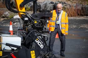 Leicestershire County Council leader Dan Harrison watching a Pothole Pro in action