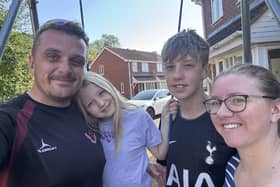 An exhausted James Marman pictured with wife Hannah and children Samuel and Jessica shortly after completing his amazing challenge