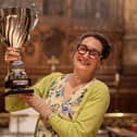 Gillian Clough lifts the Supreme Champion trophy for Tenacres Cheese dairy (Hebden Bridge) at the Artisan Cheese Awards in Melton