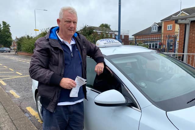 Melton taxi driver Darryl Robson with his vehicle parked on the Wilton Road rank