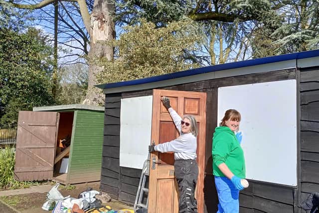 MOWS volunteers carry out renovation work on the new ticket office for the boat hire base in Melton's Wilton Park