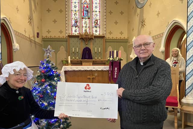 Parish priest Fr. Tom McGovern is presented with a cheque for £10,000 from fundraising activities for the new church hall close to St John's at Melton