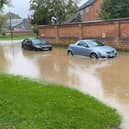 Cars struggle in flooded Mill Lane at Rearsby today