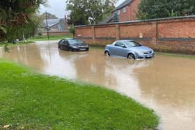 Cars struggle in flooded Mill Lane at Rearsby today